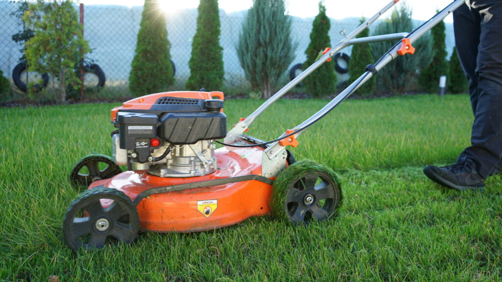 large-vecteezy_lawn-mowing-man-cutting-grass-with-his-orange-lawn-mower_22745026_large